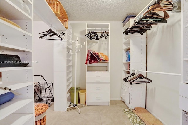 walk in closet with light tile patterned floors