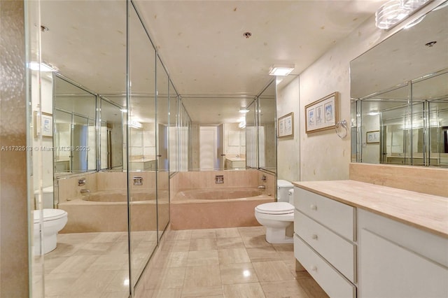 bathroom with vanity, a tub, tile patterned floors, and toilet