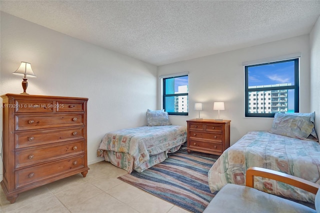 bedroom featuring a textured ceiling and light tile patterned floors