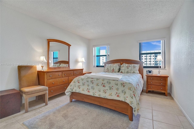 tiled bedroom featuring a textured ceiling