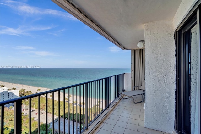 balcony with a water view and a beach view