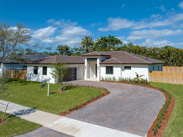 view of front facade featuring a garage and a front yard