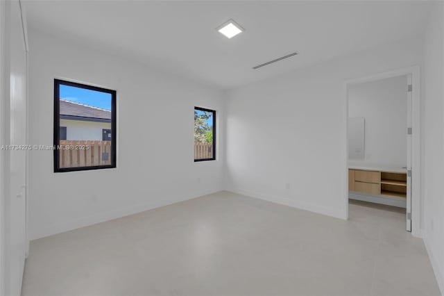 unfurnished room featuring plenty of natural light