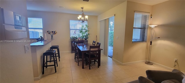 dining space with an inviting chandelier and light tile patterned floors