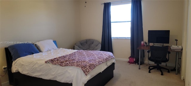 carpeted bedroom featuring multiple windows