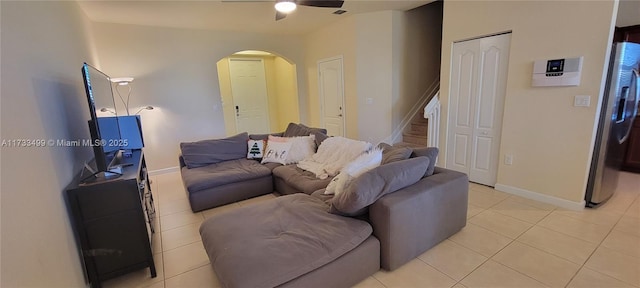 tiled living room featuring ceiling fan