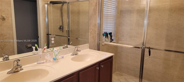 bathroom with walk in shower, tile patterned floors, and vanity