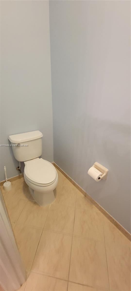 bathroom featuring tile patterned flooring and toilet