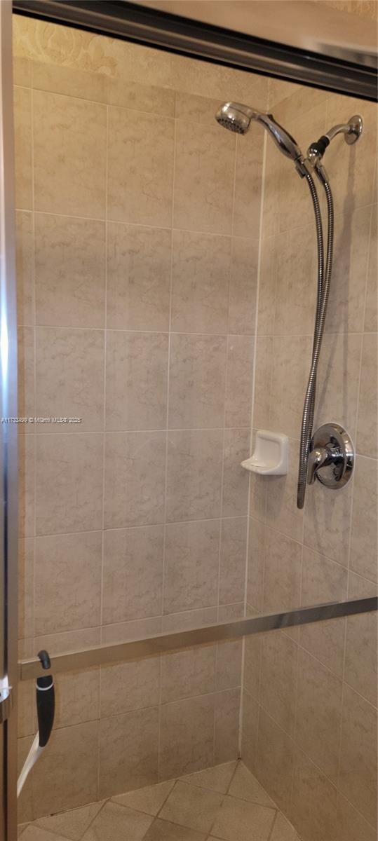 bathroom with tiled shower