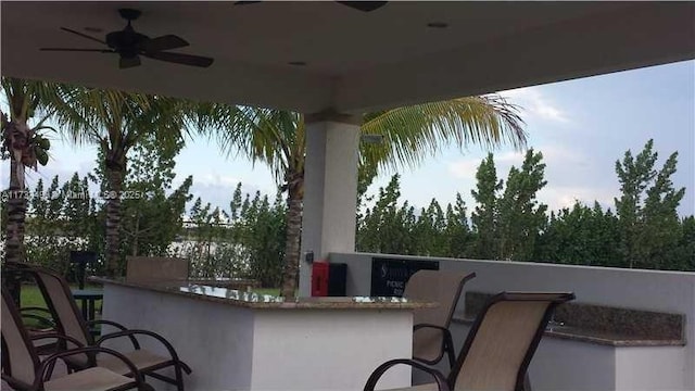 view of patio / terrace featuring a bar and ceiling fan