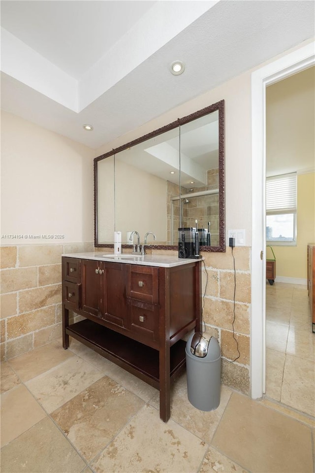 bathroom with vanity and a shower with door