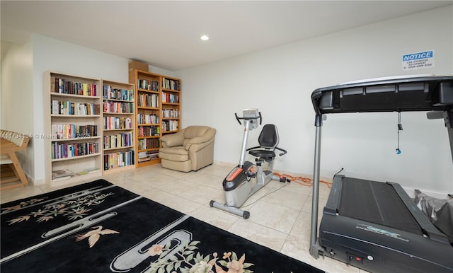 exercise room featuring light tile patterned floors