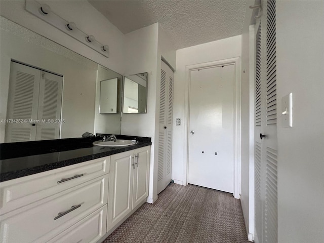 bathroom with vanity and a textured ceiling