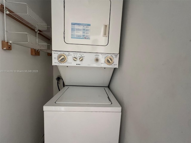 laundry area featuring stacked washer / drying machine