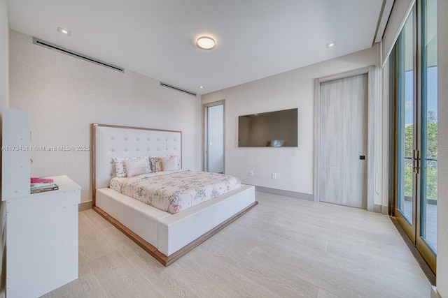 bedroom with access to outside and light wood-type flooring