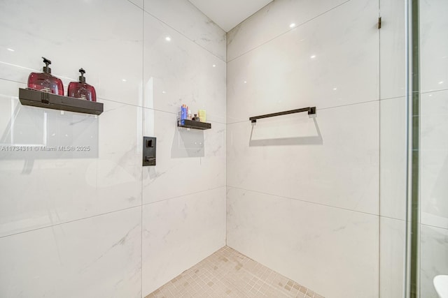 bathroom with a tile shower