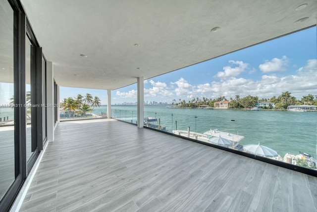 view of dock featuring a balcony and a water view