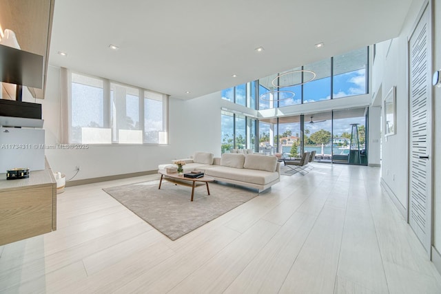 living room featuring a high ceiling and light wood-type flooring