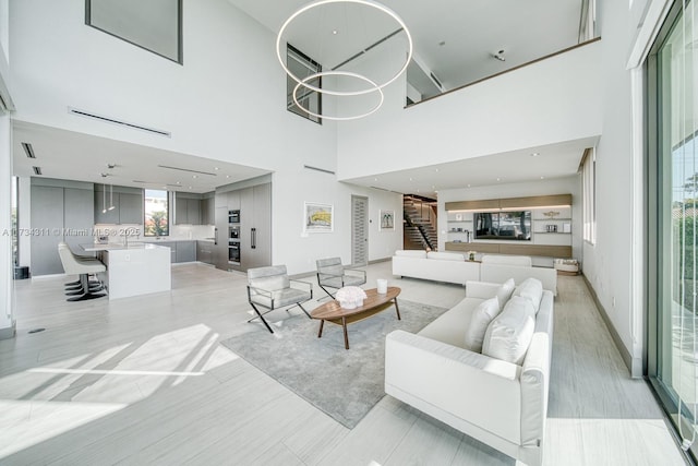 living room with sink and a high ceiling