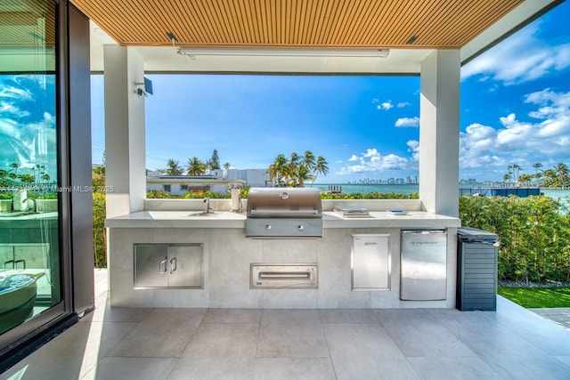 view of patio with a grill, area for grilling, and sink