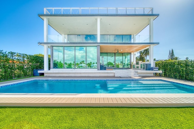 back of property with a balcony, a yard, ceiling fan, and a patio area