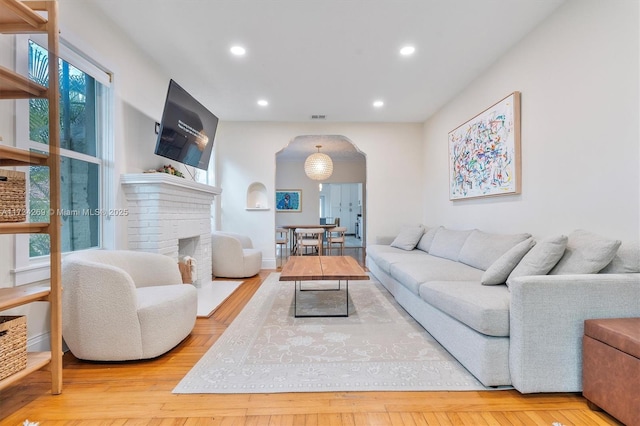 living room with light hardwood / wood-style flooring and a fireplace