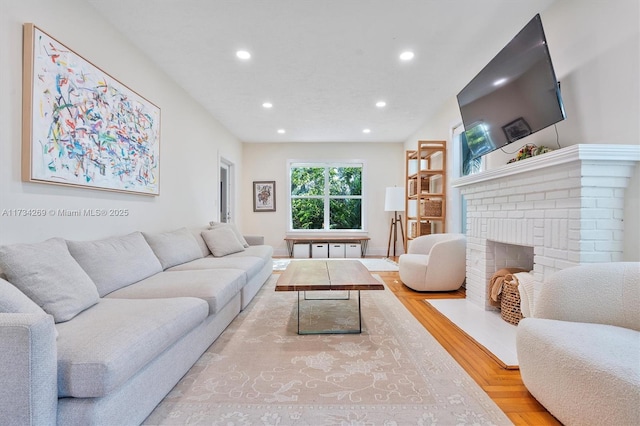 living room featuring a fireplace and light hardwood / wood-style floors