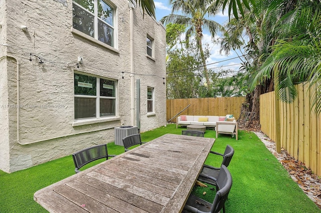 exterior space featuring cooling unit, a yard, and an outdoor hangout area