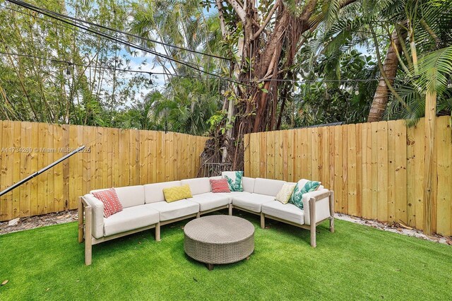 exterior space featuring outdoor lounge area and a lawn