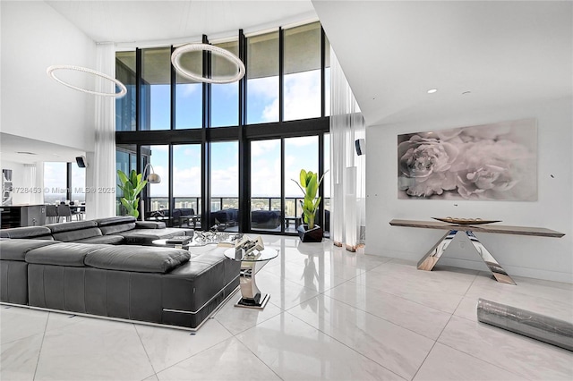 living room with light tile patterned floors and floor to ceiling windows