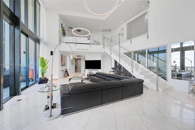 living room featuring light tile patterned flooring and a towering ceiling