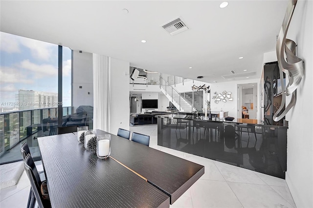 dining space with light tile patterned floors and floor to ceiling windows