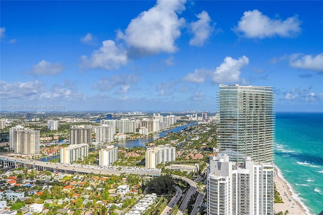 bird's eye view featuring a water view and a beach view