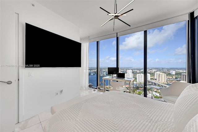 bedroom with light tile patterned floors, an inviting chandelier, multiple windows, and a wall of windows