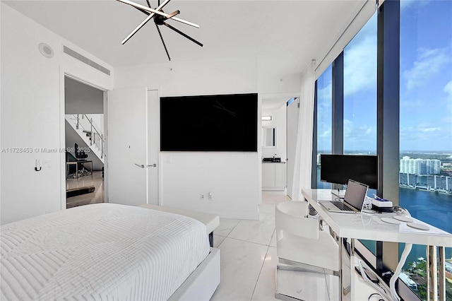 bedroom with expansive windows and a notable chandelier