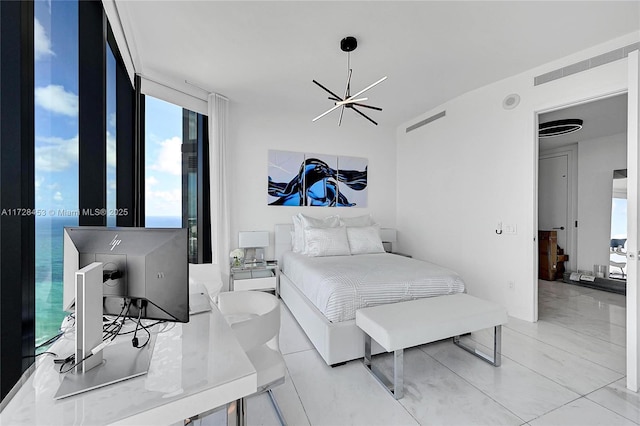 bedroom featuring expansive windows and a notable chandelier