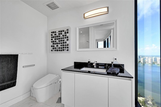 bathroom featuring vanity and toilet