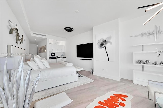 bedroom with light hardwood / wood-style floors