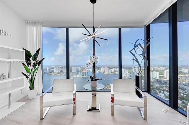 sunroom featuring a notable chandelier and a water view