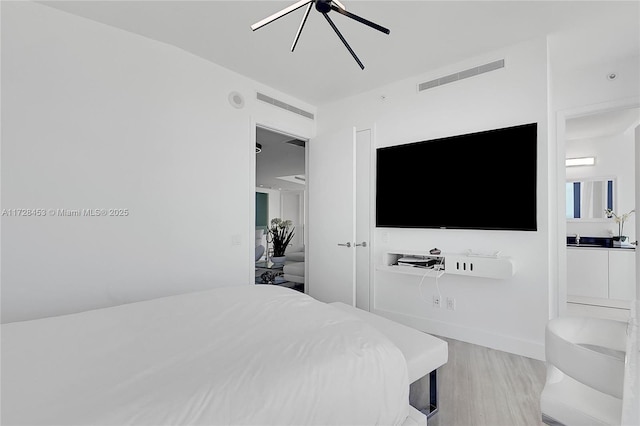 bedroom with ceiling fan and light hardwood / wood-style flooring