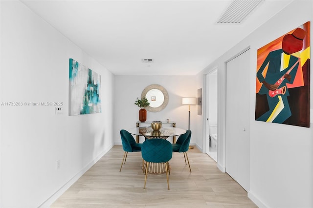 dining space featuring light wood-type flooring