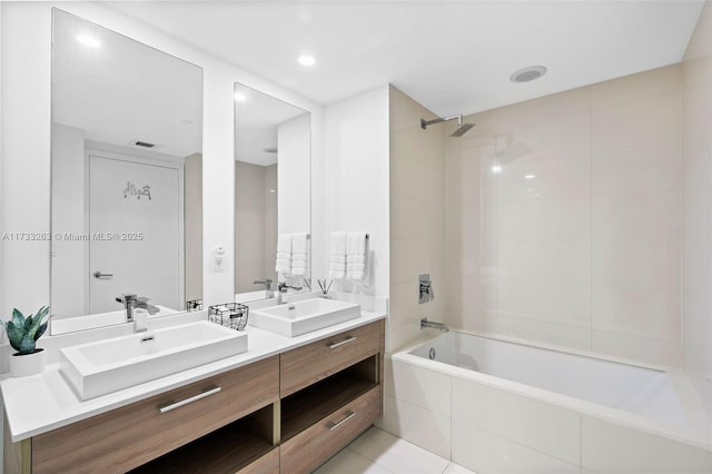 bathroom with tiled shower / bath, vanity, and tile patterned floors