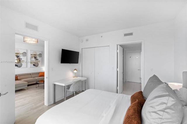 bedroom featuring a closet and light wood-type flooring