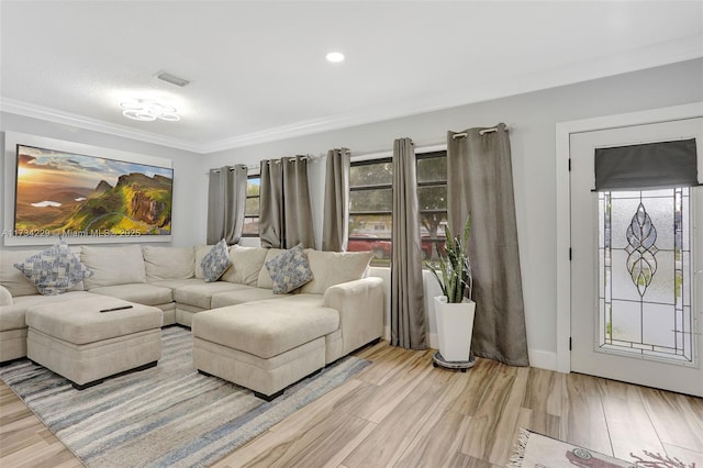 living room featuring light hardwood / wood-style flooring and ornamental molding