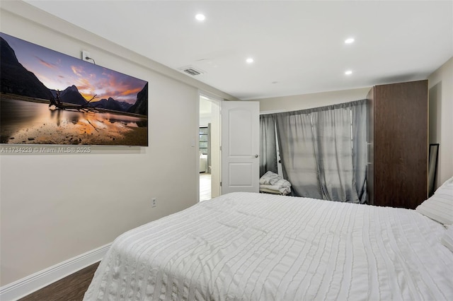 bedroom with hardwood / wood-style floors