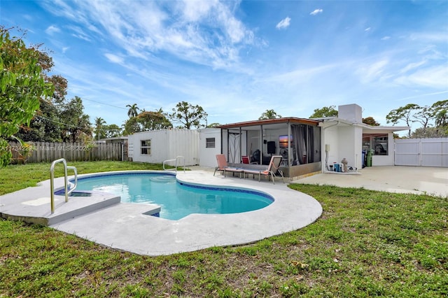 view of pool with a lawn, a sunroom, and a patio