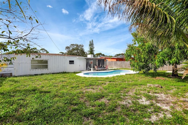 view of yard with a fenced in pool