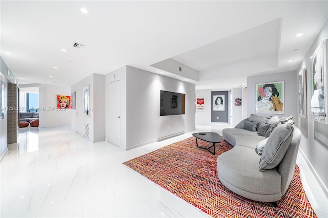 living room featuring a tray ceiling