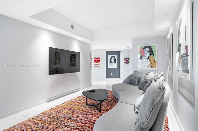 living room with a tray ceiling