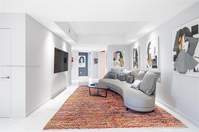 living room featuring a tray ceiling